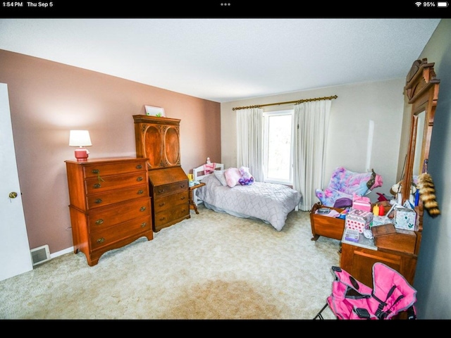 bedroom featuring light carpet