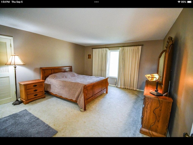 bedroom featuring light carpet