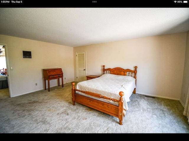 carpeted bedroom with a textured ceiling