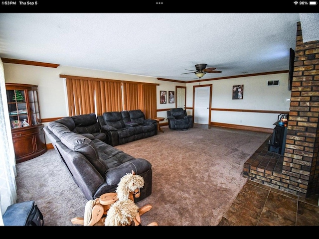 living room with ceiling fan, ornamental molding, a textured ceiling, and dark colored carpet