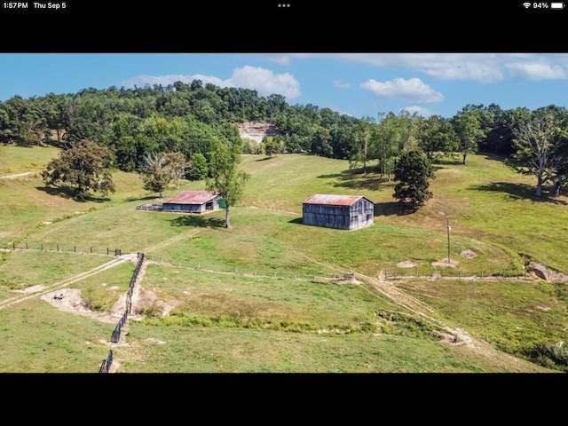 birds eye view of property with a rural view