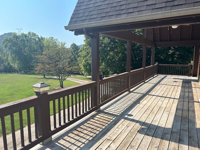 wooden terrace featuring a yard