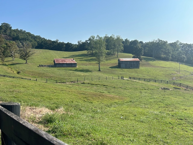 view of yard with a rural view and an outbuilding