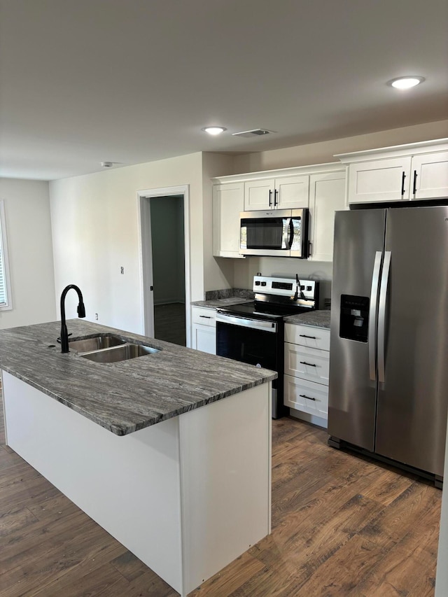 kitchen featuring sink, appliances with stainless steel finishes, dark wood-type flooring, and white cabinets