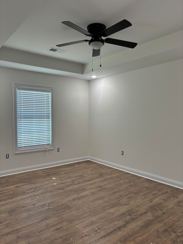 unfurnished room with dark hardwood / wood-style floors and ceiling fan