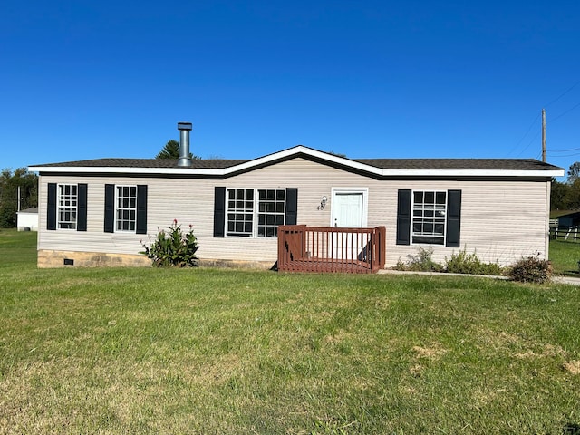 rear view of property featuring a deck and a lawn