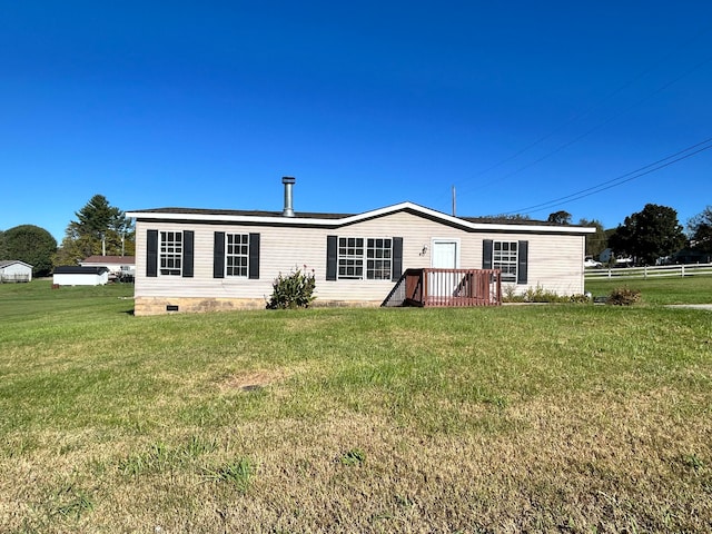 rear view of property featuring a wooden deck and a yard