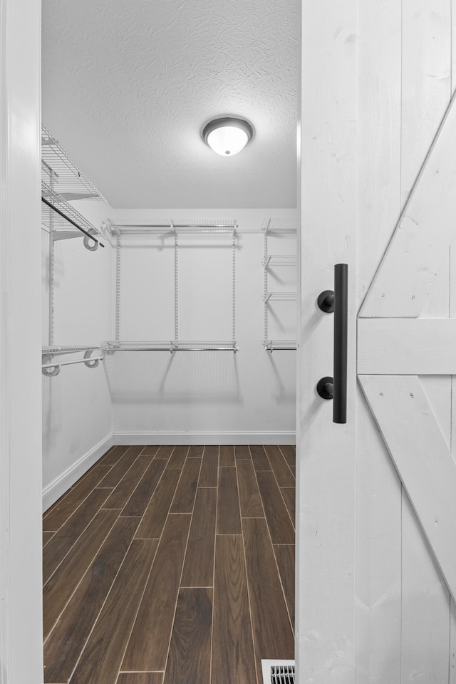 walk in closet featuring dark hardwood / wood-style floors