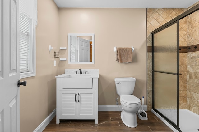 bathroom with toilet, walk in shower, and vanity