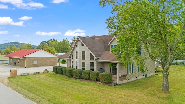 back of property with a yard and a garage