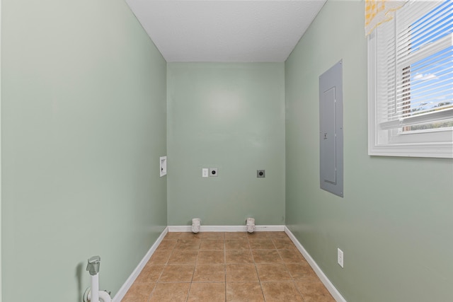 laundry room featuring electric panel, electric dryer hookup, a textured ceiling, and light tile patterned floors