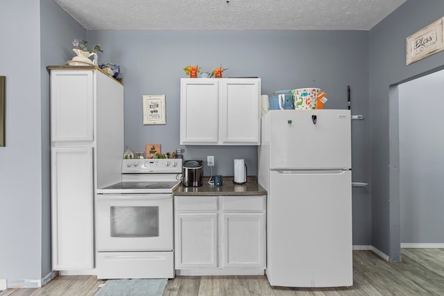 kitchen with light hardwood / wood-style floors, white cabinets, a textured ceiling, and white appliances