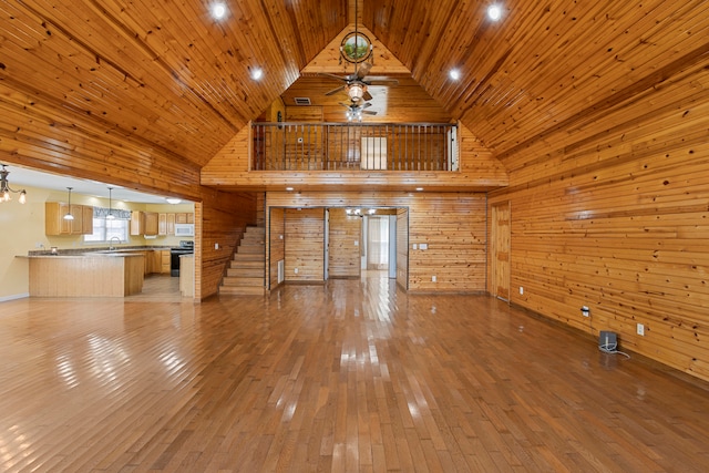 unfurnished living room with wood ceiling, high vaulted ceiling, and light hardwood / wood-style floors