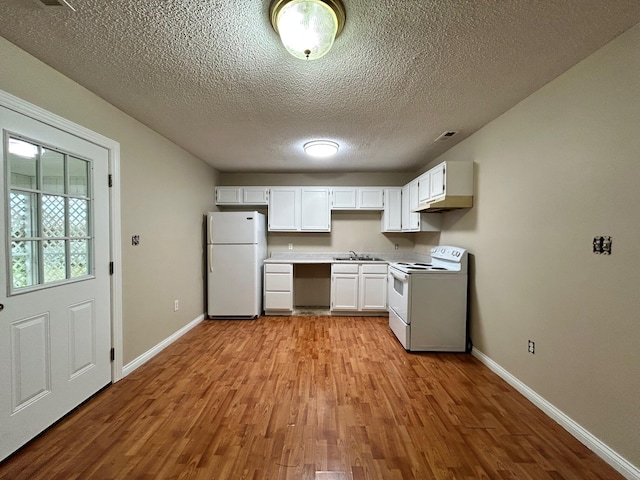 kitchen with light wood-type flooring, a textured ceiling, white appliances, sink, and white cabinetry