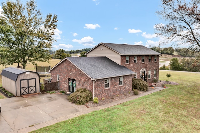 view of side of home featuring a lawn and a storage shed