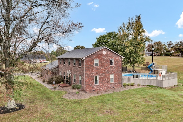 rear view of property featuring a lawn