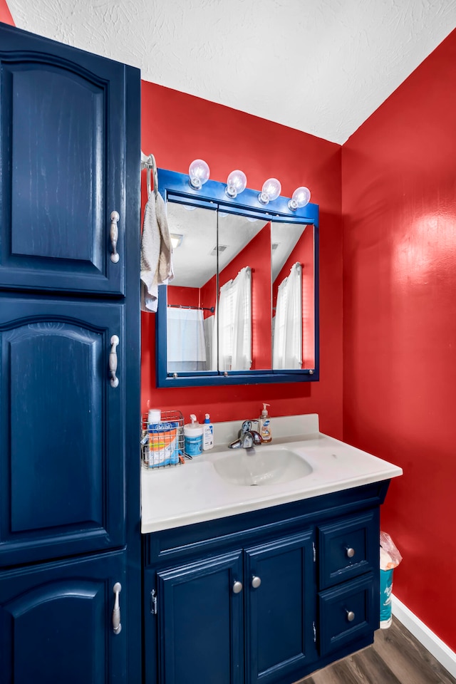 bathroom with vanity and hardwood / wood-style floors