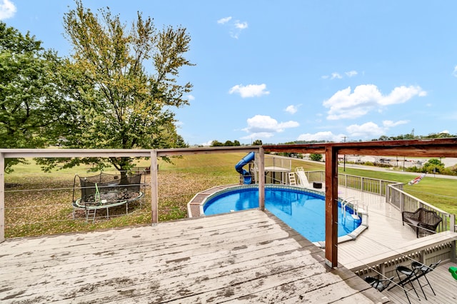 view of swimming pool with a wooden deck