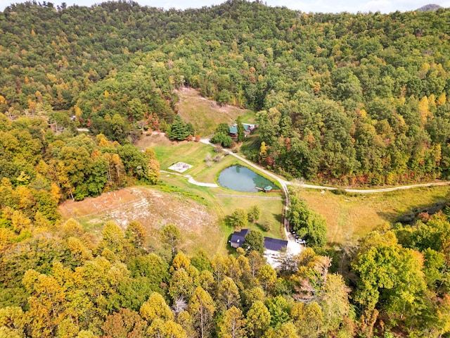 aerial view featuring a view of trees and a water view