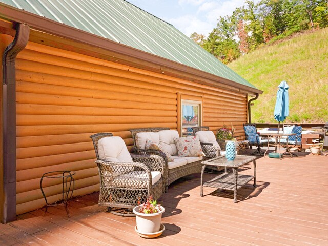 wooden terrace featuring an outdoor hangout area