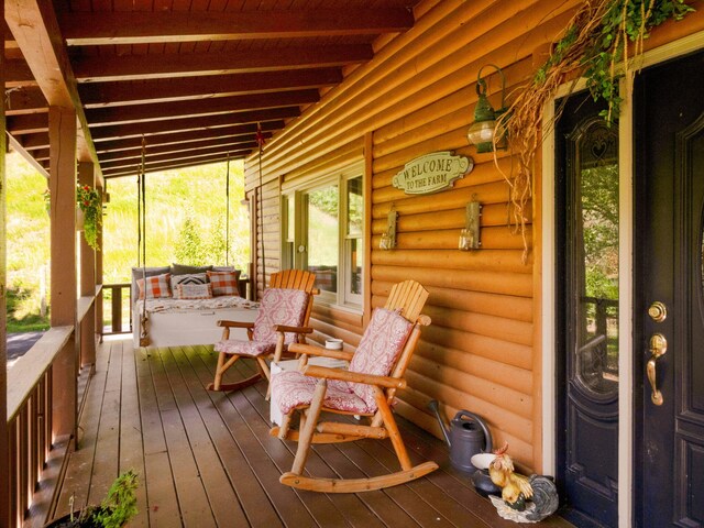 wooden terrace with a porch