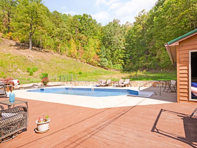 view of swimming pool with a deck