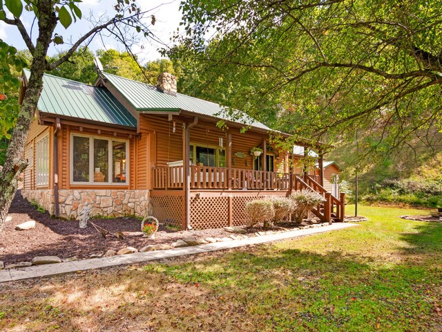 log-style house with a front yard