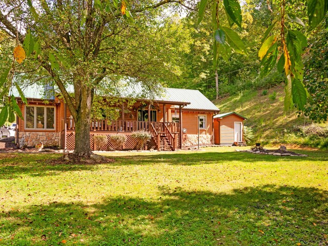 view of front of home with a wooden deck and a front lawn