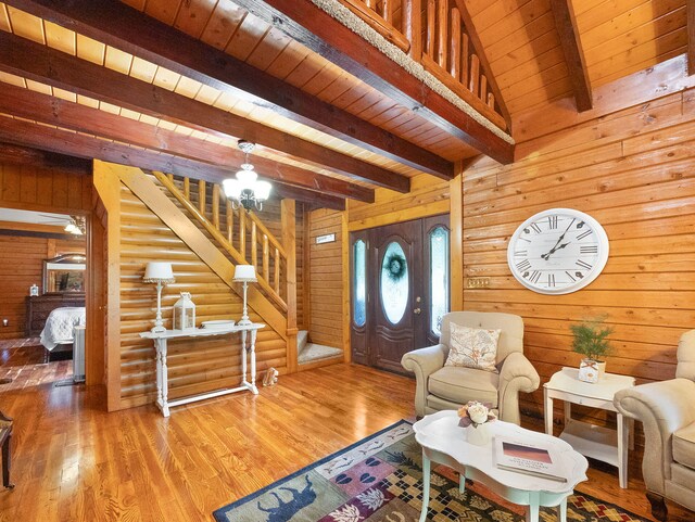 living room featuring wood ceiling, beam ceiling, wood walls, and hardwood / wood-style flooring