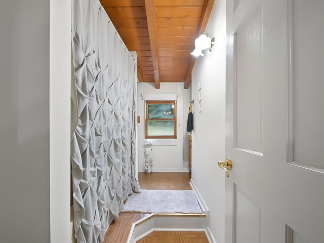 bathroom featuring beamed ceiling, wooden ceiling, and hardwood / wood-style flooring