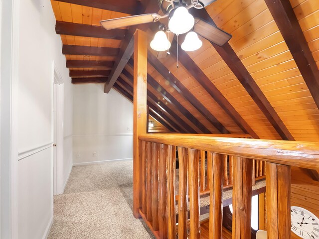 hallway featuring wooden ceiling, lofted ceiling with beams, and light colored carpet