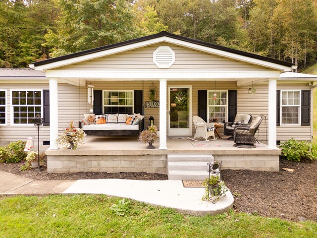 back of property with covered porch