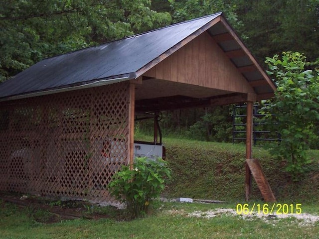 view of home's community featuring a carport and a view of trees