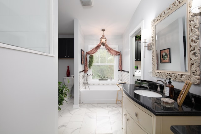 bathroom with vanity and a tub