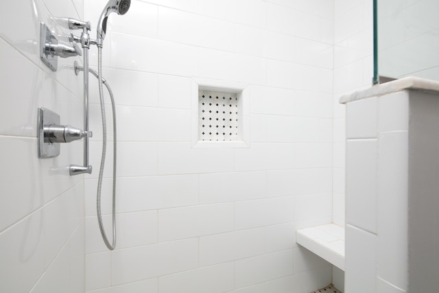 bathroom with a tile shower