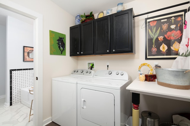 washroom with washer and clothes dryer and cabinets