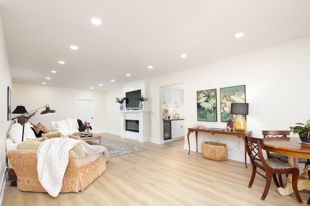 living room featuring sink and light hardwood / wood-style flooring