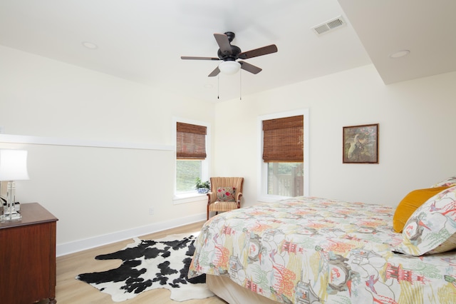 bedroom with light hardwood / wood-style floors and ceiling fan