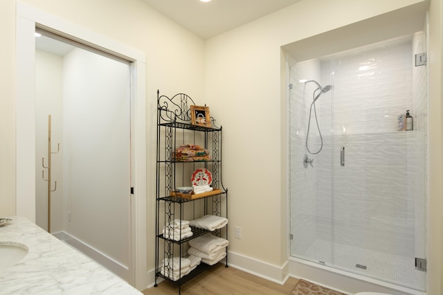 bathroom featuring vanity, wood-type flooring, and an enclosed shower