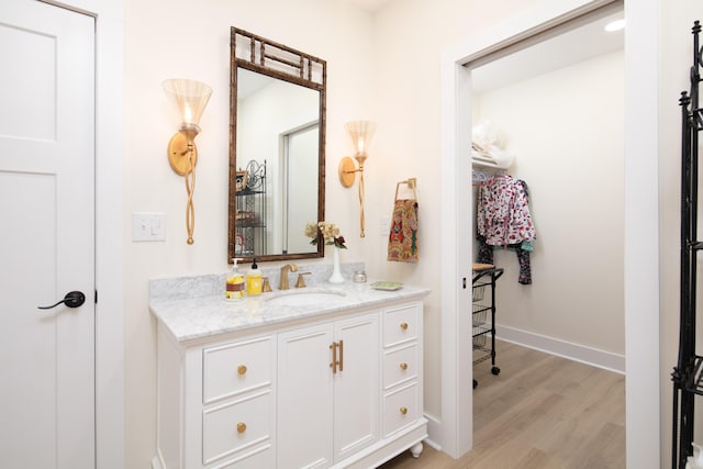 bathroom with hardwood / wood-style floors and vanity