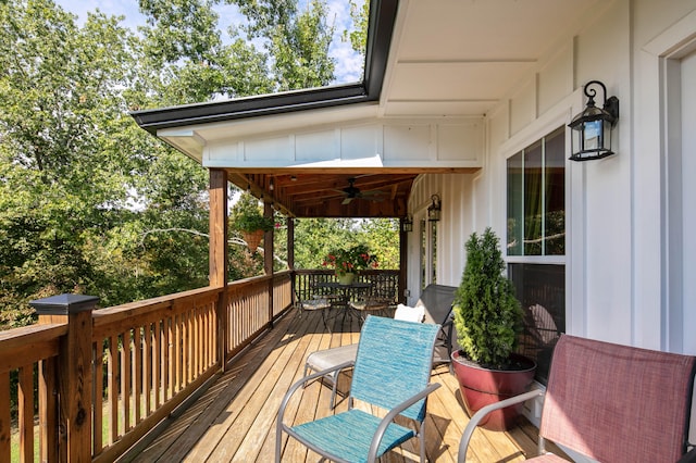 wooden deck featuring ceiling fan