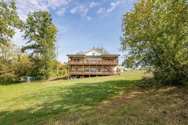 back of house with a lawn and a deck