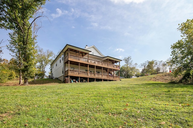 back of property featuring a lawn