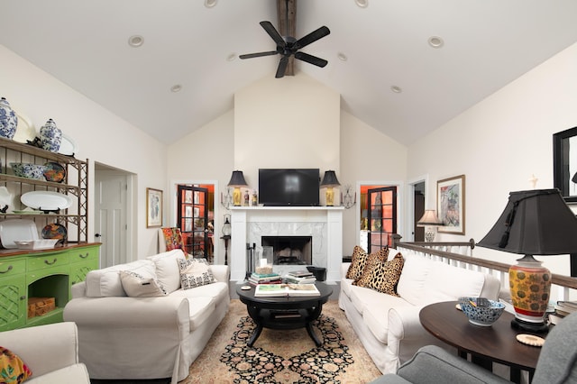 living room featuring high vaulted ceiling, ceiling fan, and a high end fireplace