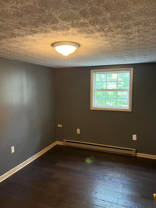 empty room featuring a baseboard radiator, a textured ceiling, and dark wood-type flooring