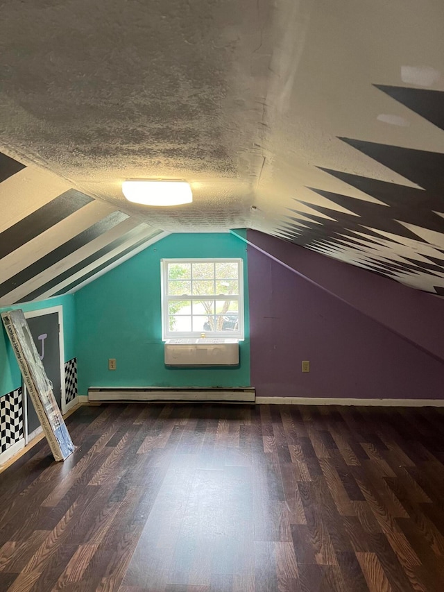 additional living space with a textured ceiling, baseboard heating, vaulted ceiling, and dark hardwood / wood-style flooring