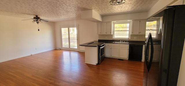 kitchen with backsplash, black appliances, white cabinets, a textured ceiling, and wood-type flooring