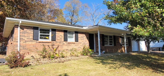 ranch-style home with a front yard and a garage