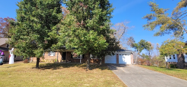 view of property hidden behind natural elements with a garage and a front lawn