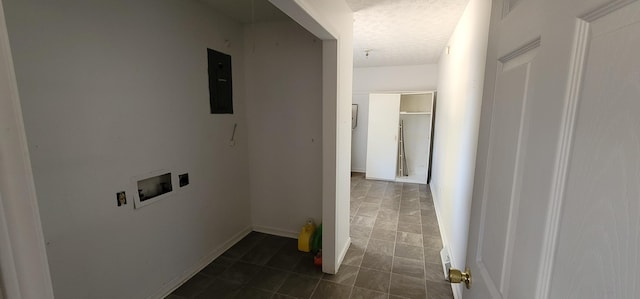 clothes washing area with washer hookup, a textured ceiling, and electric panel